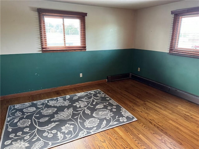 spare room featuring wood-type flooring