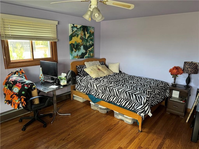 bedroom featuring ceiling fan and dark hardwood / wood-style floors