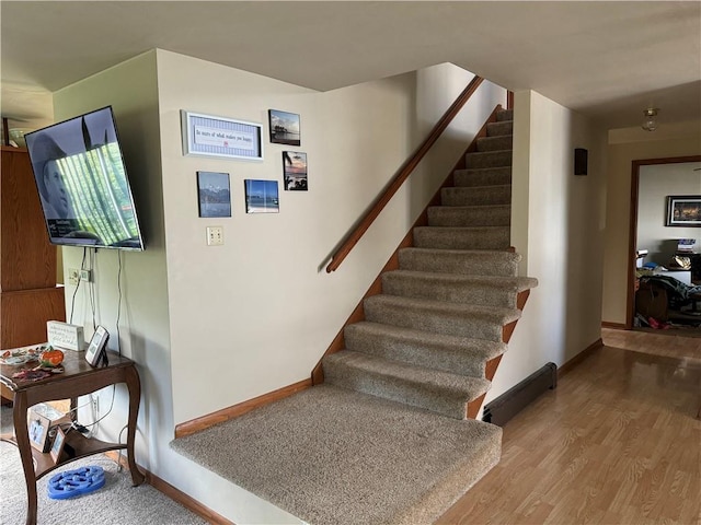 staircase with wood-type flooring