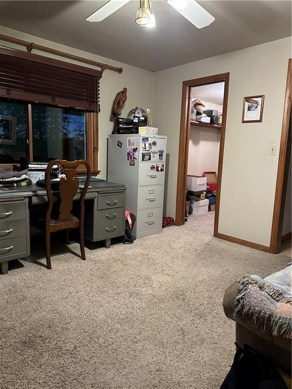 interior space with ceiling fan, white refrigerator, and light colored carpet