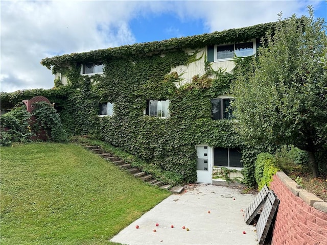 view of side of home with a yard