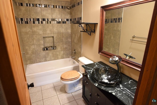 full bathroom featuring tiled shower / bath combo, vanity, toilet, and tile patterned floors