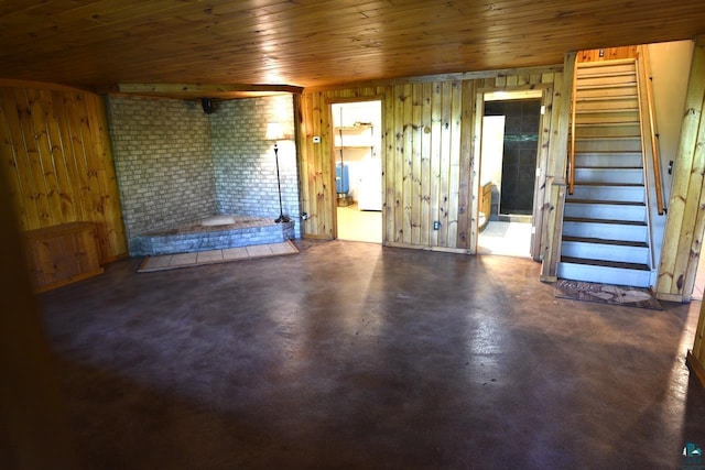 interior space featuring a fireplace, wood walls, and wooden ceiling