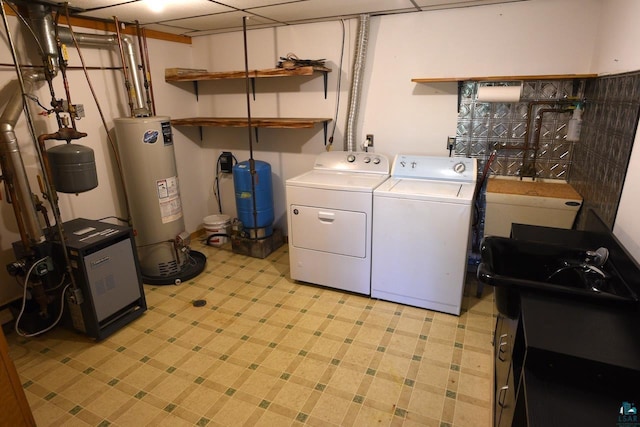 laundry room featuring gas water heater and washer and dryer