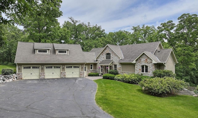 view of front of house featuring a garage and a front lawn