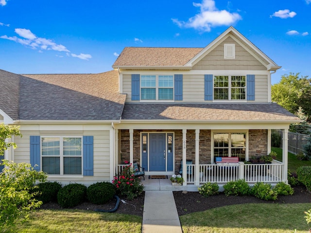 view of front facade with a front lawn and covered porch