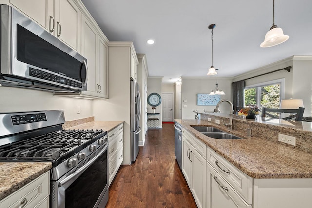 kitchen featuring stainless steel appliances, dark hardwood / wood-style floors, hanging light fixtures, and sink