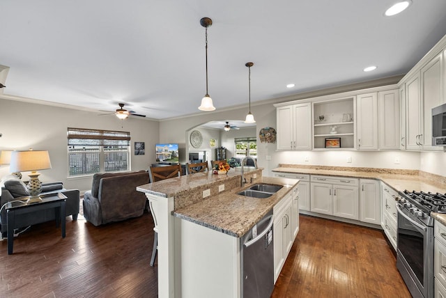 kitchen featuring sink, white cabinets, appliances with stainless steel finishes, decorative light fixtures, and ceiling fan