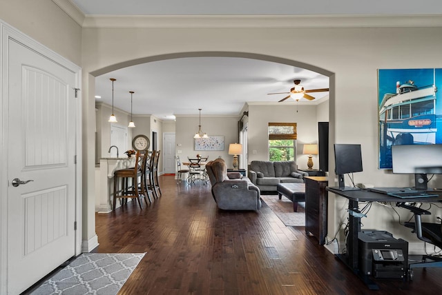 living room featuring ornamental molding, dark hardwood / wood-style floors, and ceiling fan