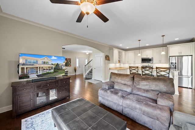 living room featuring crown molding, dark hardwood / wood-style flooring, and ceiling fan