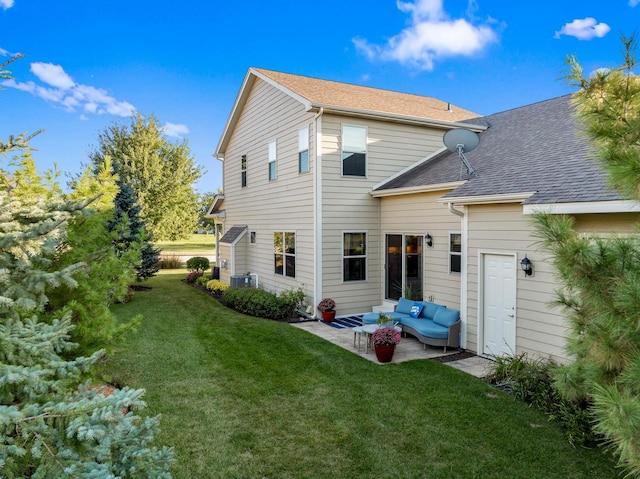 back of house with a lawn, an outdoor living space, a patio, and central AC