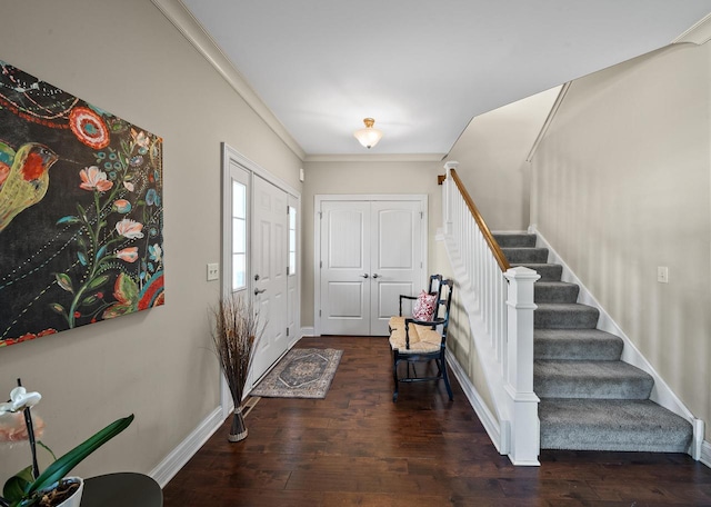 entryway with crown molding and dark hardwood / wood-style flooring