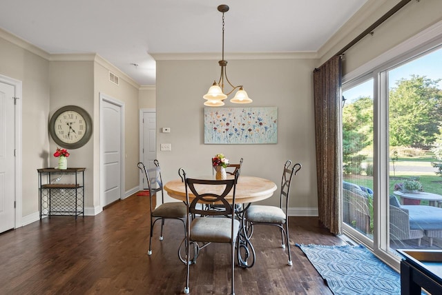 dining area featuring an inviting chandelier, crown molding, and dark hardwood / wood-style flooring