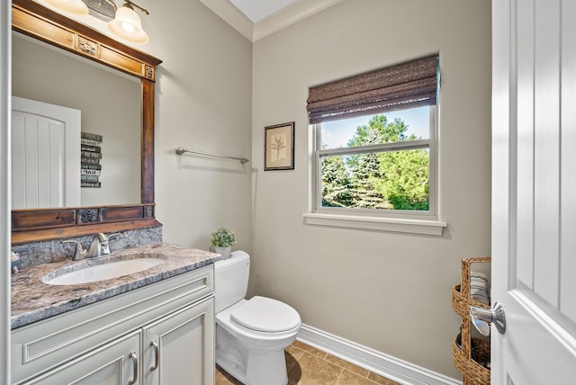 bathroom featuring ornamental molding, vanity, tile patterned flooring, and toilet