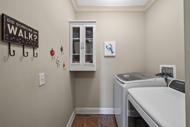 laundry area with crown molding and washer and dryer