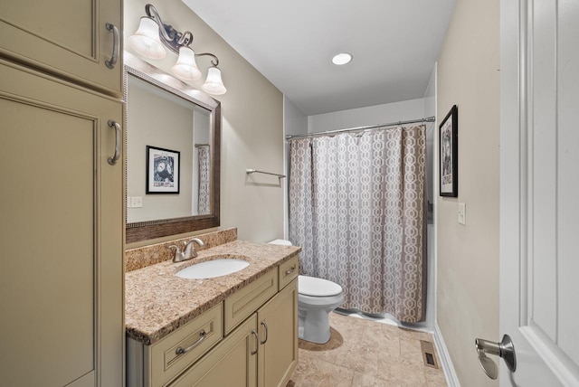 bathroom featuring walk in shower, vanity, and toilet