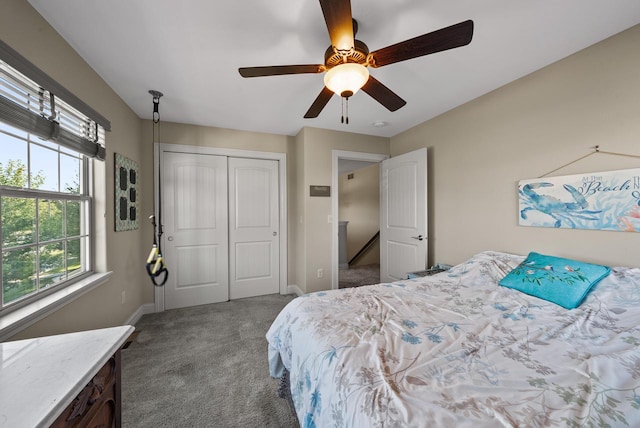 carpeted bedroom featuring a closet and ceiling fan