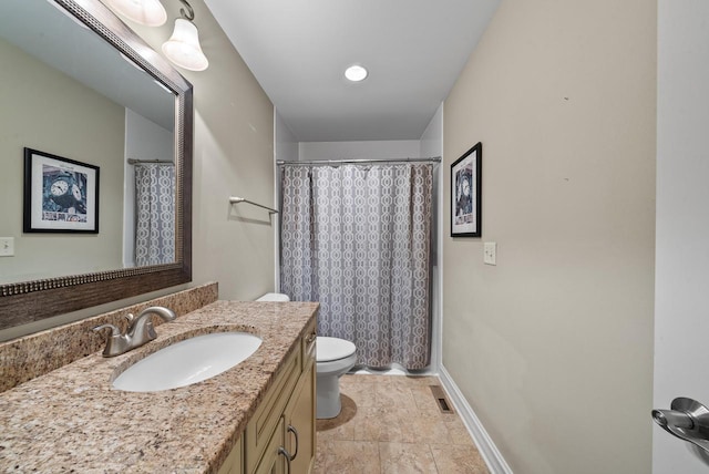 bathroom featuring curtained shower, vanity, and toilet