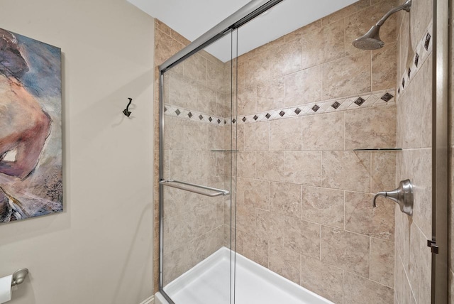 bathroom featuring a shower with door