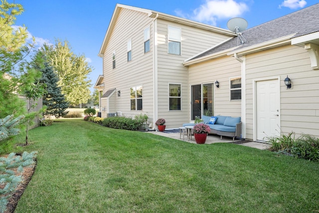 rear view of house with a patio, a lawn, and an outdoor hangout area