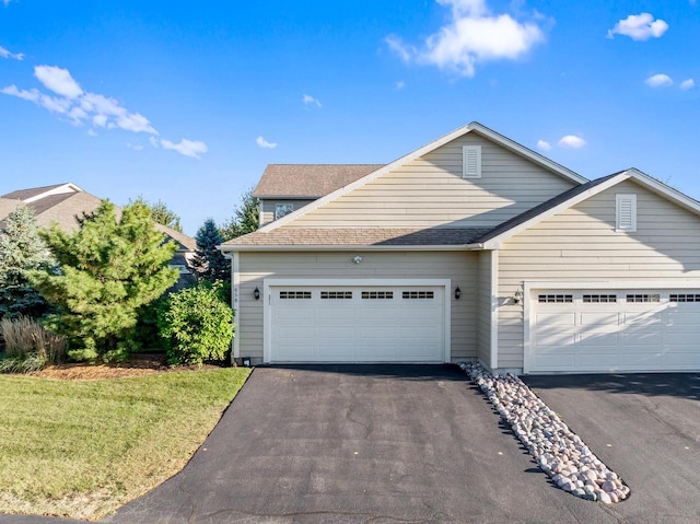 front of property with a garage and a front yard