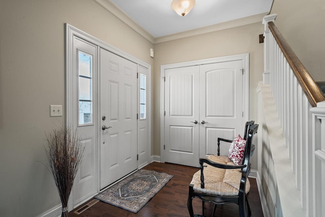 foyer with crown molding and dark hardwood / wood-style flooring