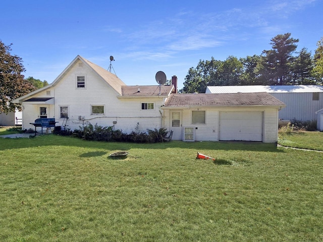 back of property featuring a yard