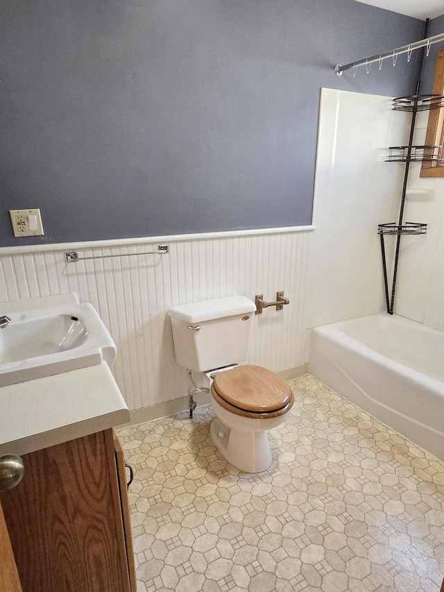 full bathroom featuring vanity, bathtub / shower combination, and toilet