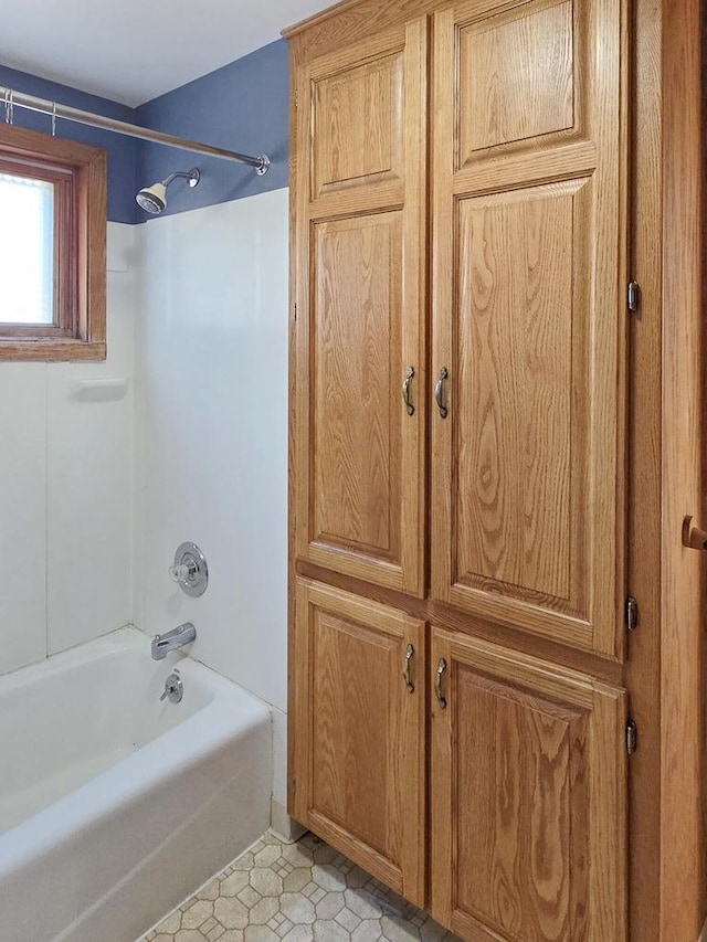 bathroom featuring shower / bathing tub combination and tile patterned floors