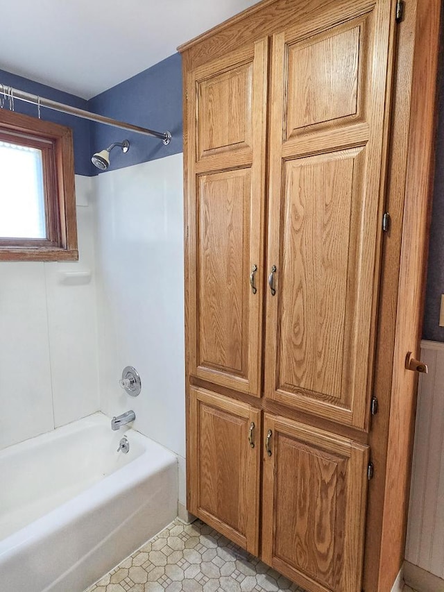 bathroom with tile patterned flooring and shower / bath combination