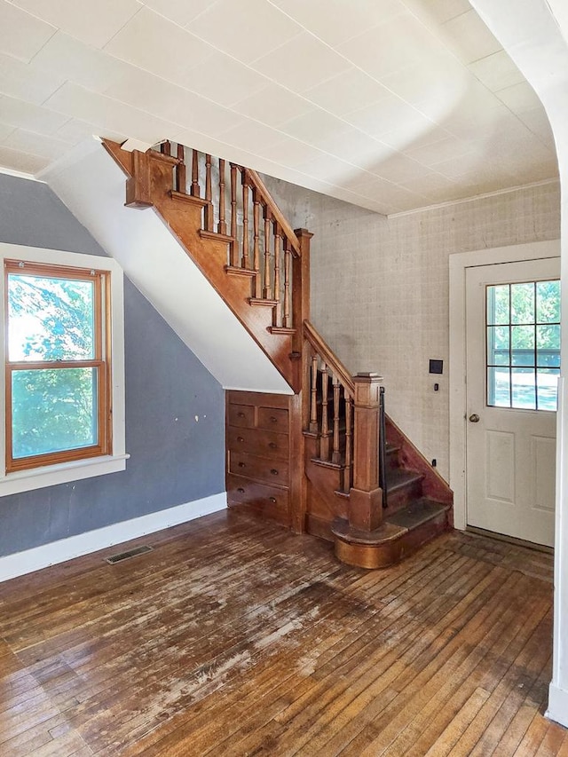 entrance foyer with lofted ceiling and dark hardwood / wood-style floors