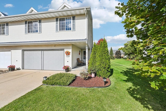 view of front of home with a front yard and a garage