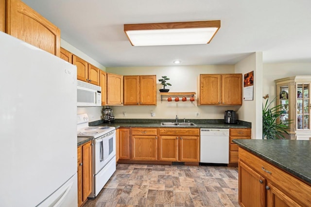 kitchen featuring white appliances and sink