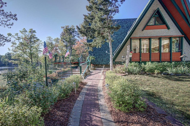 view of side of home featuring a lawn