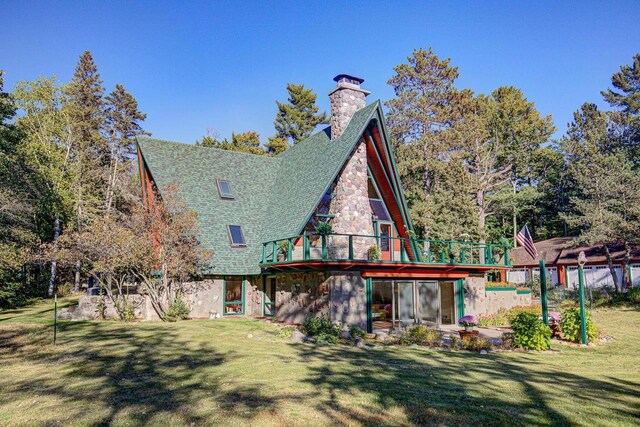 6147 County Rd E, Phelps, WI 54554 - rear view of property featuring a chimney, roof with shingles, a wooden deck, a yard, and stone siding