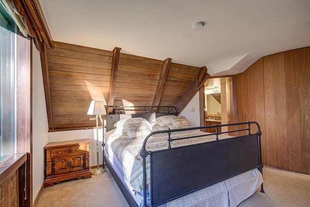 carpeted bedroom featuring lofted ceiling with beams and wood walls