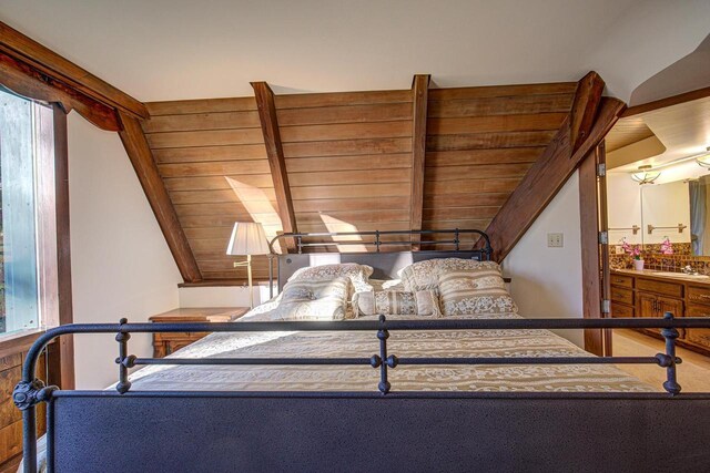 6147 County Rd E, Phelps, WI 54554 - bedroom with lofted ceiling with beams and a sink