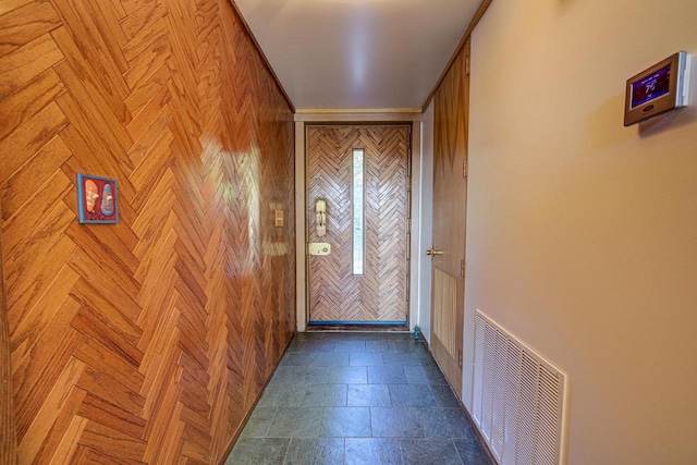 entryway with wooden walls