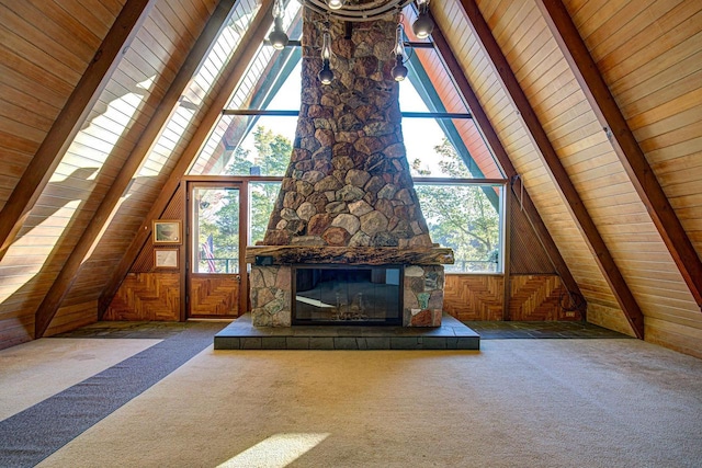 unfurnished living room with wood walls, carpet, and a fireplace