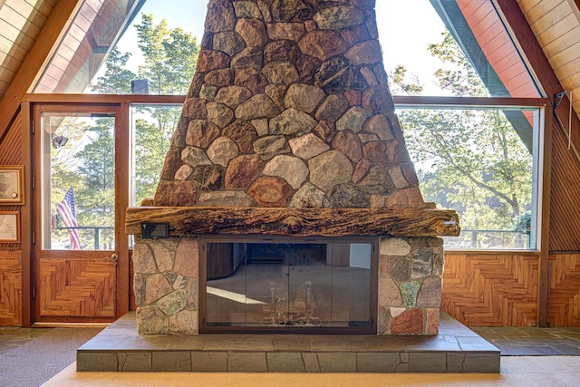 details featuring beamed ceiling, wooden walls, a fireplace, and wooden ceiling