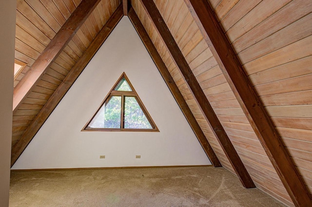 additional living space featuring carpet, vaulted ceiling with beams, and wooden ceiling