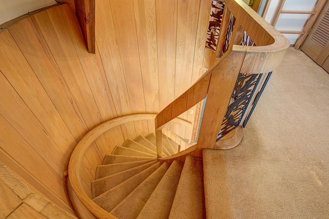 stairs featuring wooden walls