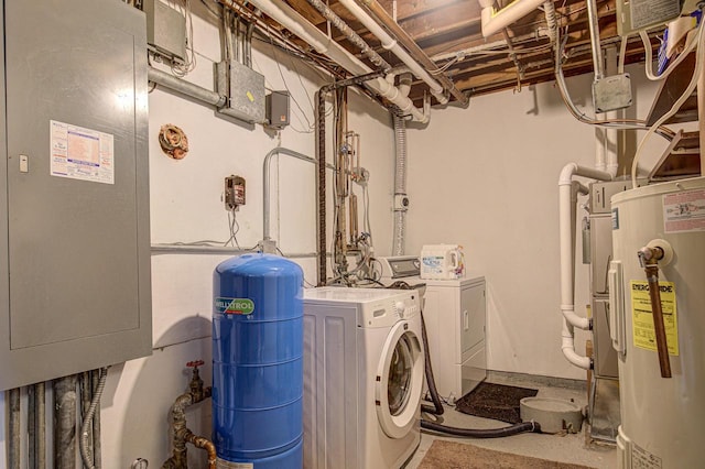 clothes washing area with electric water heater and washer and dryer