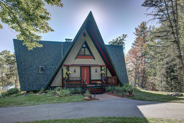 6147 County Rd E, Phelps, WI 54554 - a-frame home featuring covered porch, a shingled roof, and a front yard