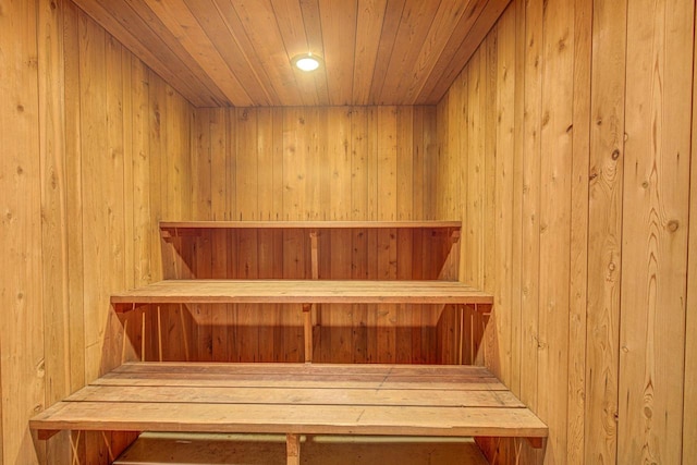 view of sauna with wood ceiling and wood walls