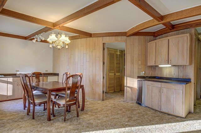 6147 County Rd E, Phelps, WI 54554 - dining space featuring wood walls, coffered ceiling, and beamed ceiling