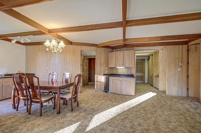 carpeted dining area featuring wood walls, beamed ceiling, and an inviting chandelier