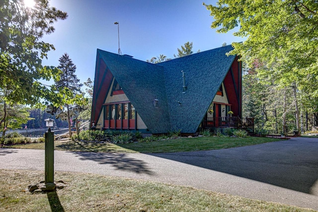 6147 County Rd E, Phelps, WI 54554 - view of side of home with a lawn and roof with shingles