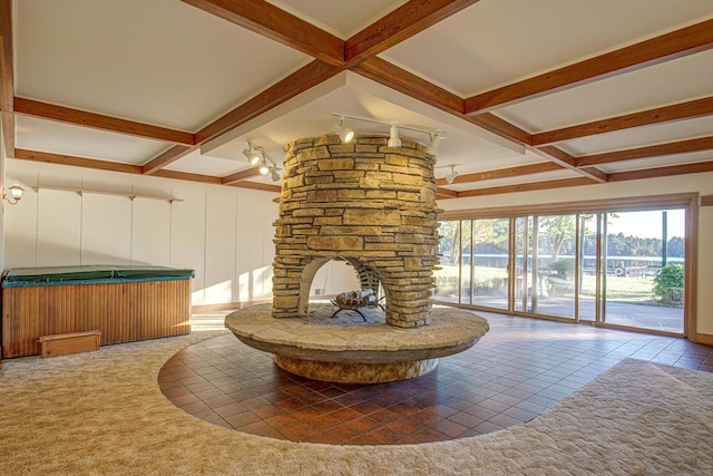 interior space with beam ceiling, tile patterned floors, and a fireplace