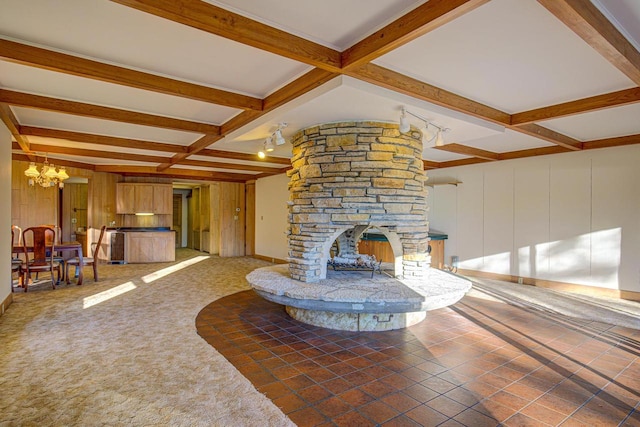 living room featuring a chandelier, beamed ceiling, coffered ceiling, and a fireplace